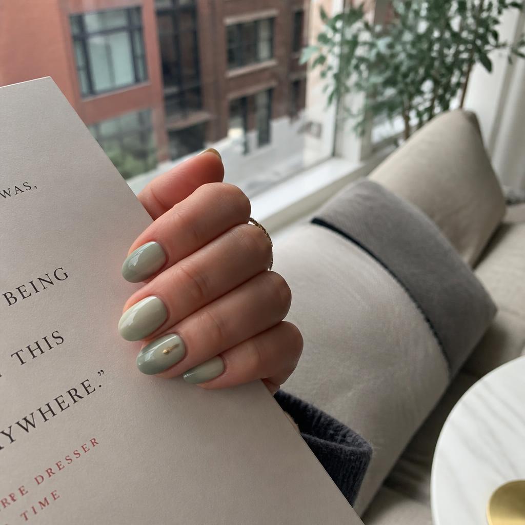 Sage green gel nails with gold accent